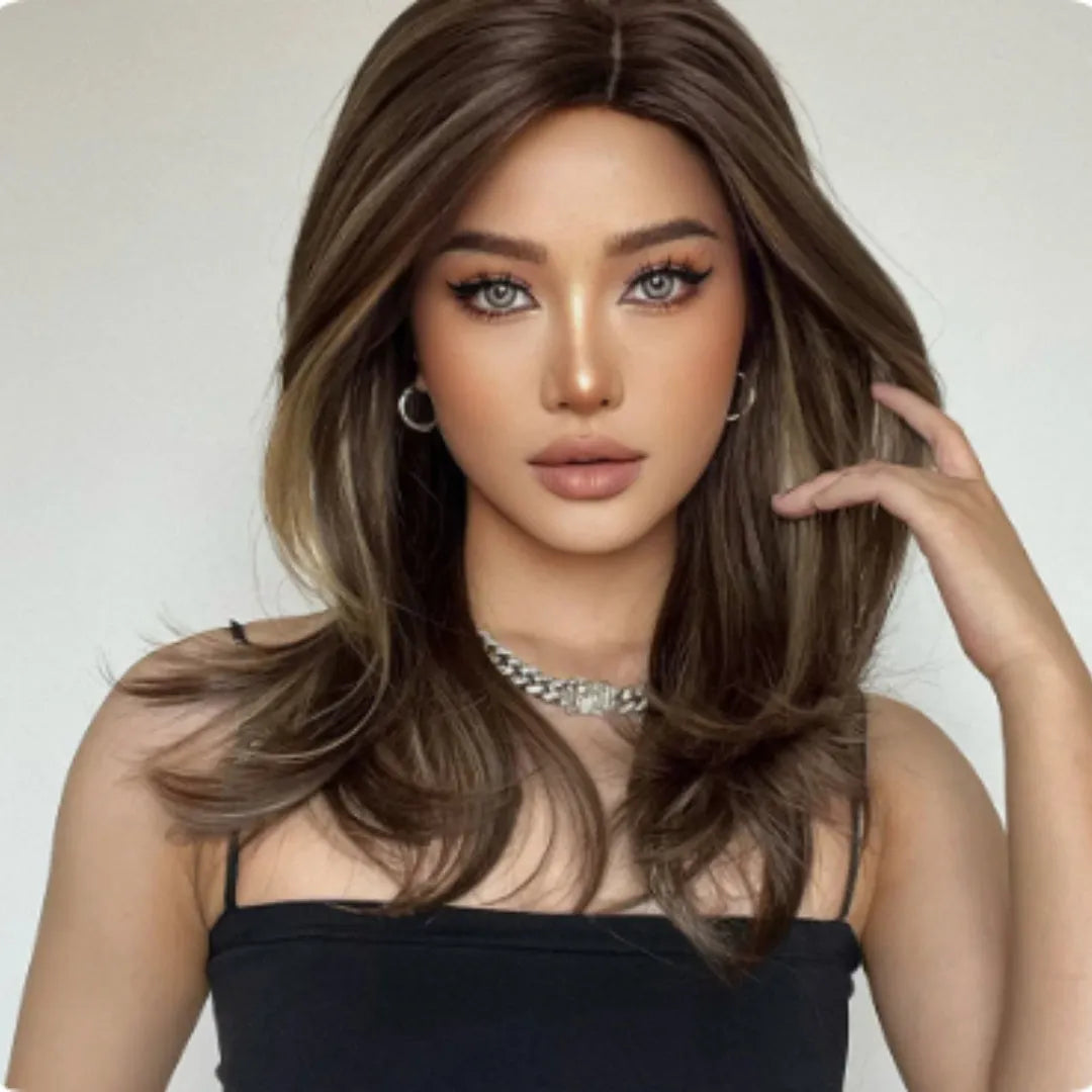 Mid-length curly synthetic wig with long bangs in a platinum gradient colour, shown on a wig stand.