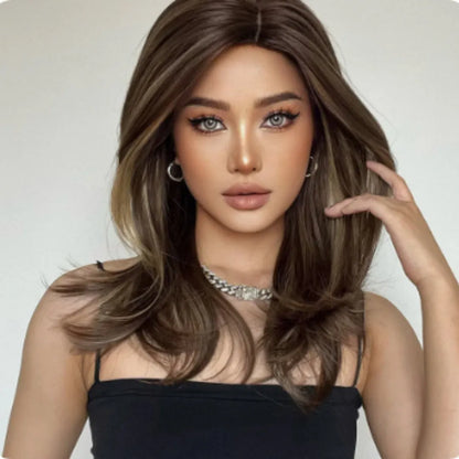 Mid-length curly synthetic wig with long bangs in a platinum gradient colour, shown on a wig stand.