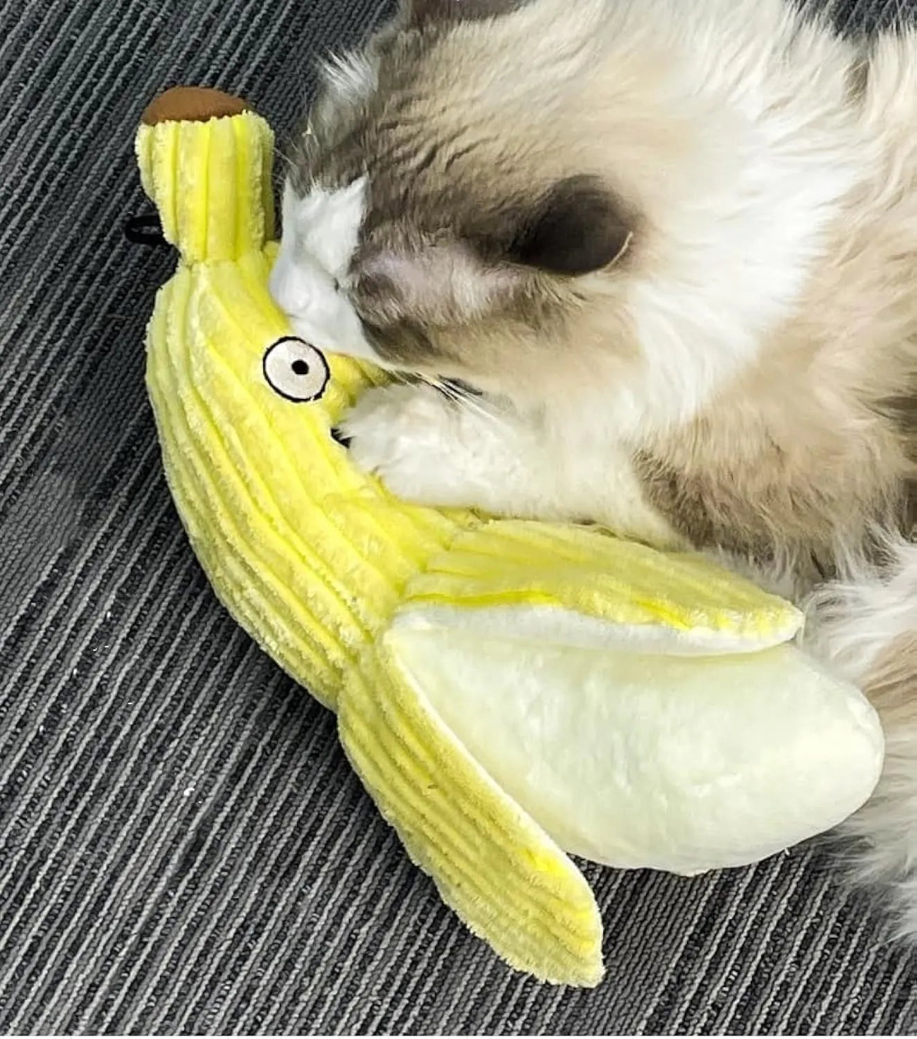 Yellow banana-shaped plush cat toy with a green leaf and crinkle paper inside for sound.
