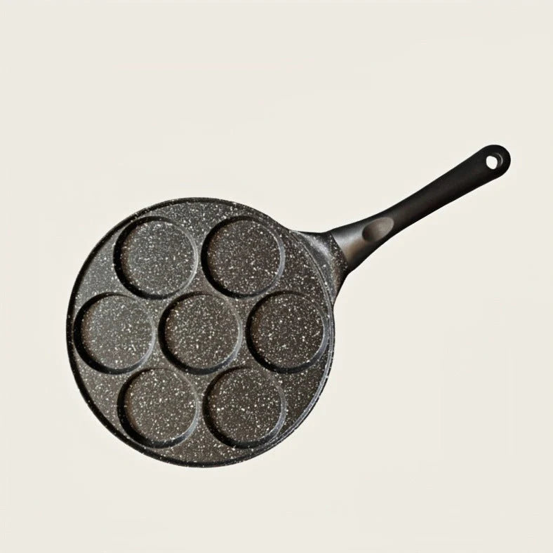 Seven-hole aluminium barbecue plate with non-stick surface on gas hob