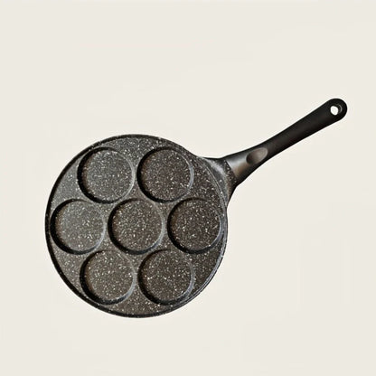 Seven-hole aluminium barbecue plate with non-stick surface on gas hob