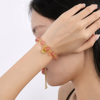 Strawberry quartz bracelet with gold electroplated metal and engraved fu character geometric jewellery design