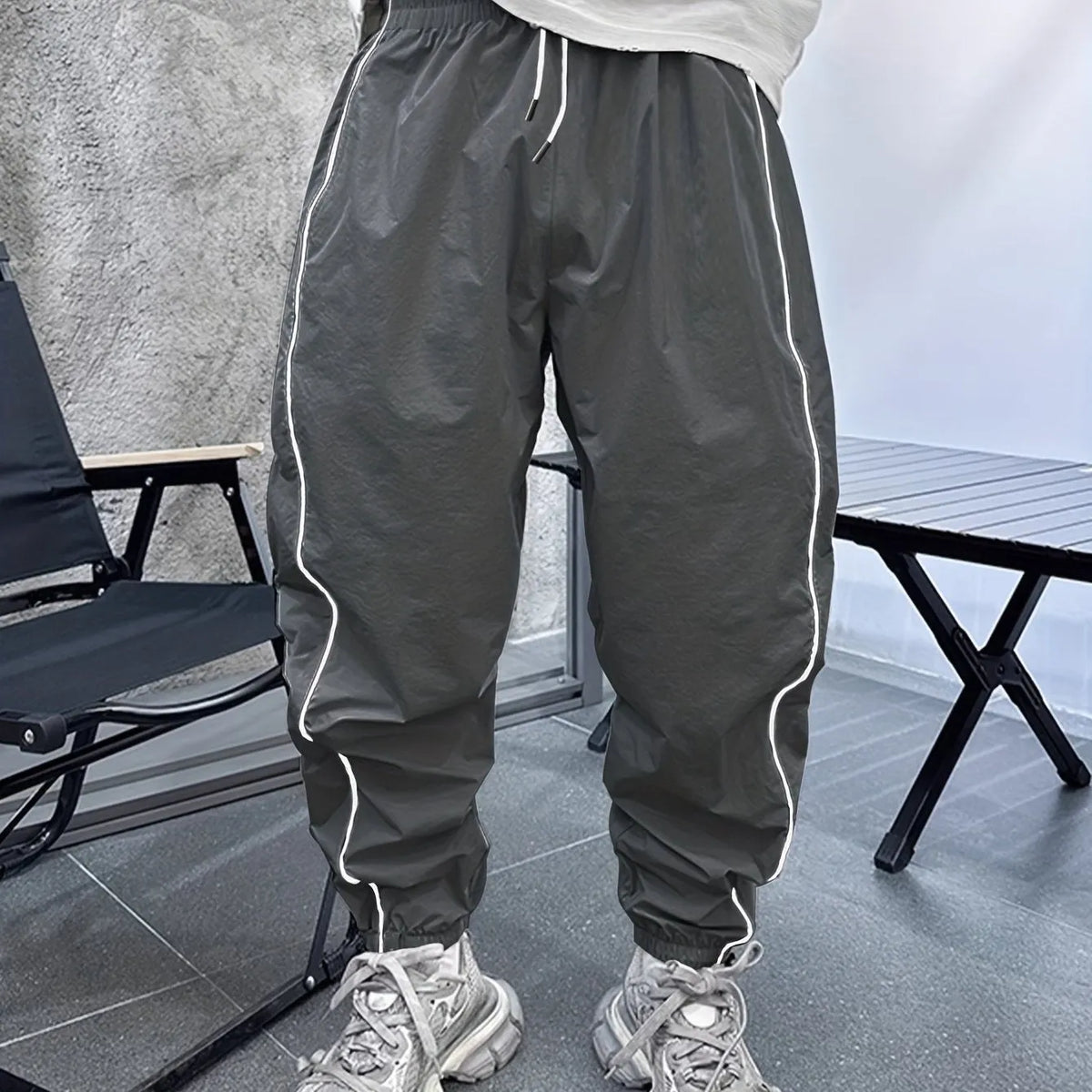 Men's bamboo fibre cropped sports trousers in army green colour showing loose fit and elastic waistband