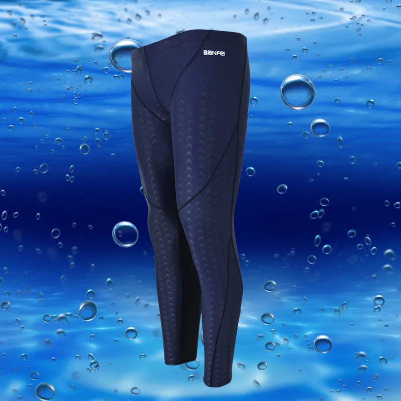 Men's black and grey cropped nylon swimming trunks with mesh lining, laid flat.