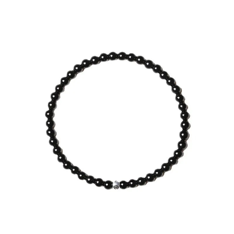 Geometric unisex bracelet with small Obsidian, blue San, and textured black agate beads.