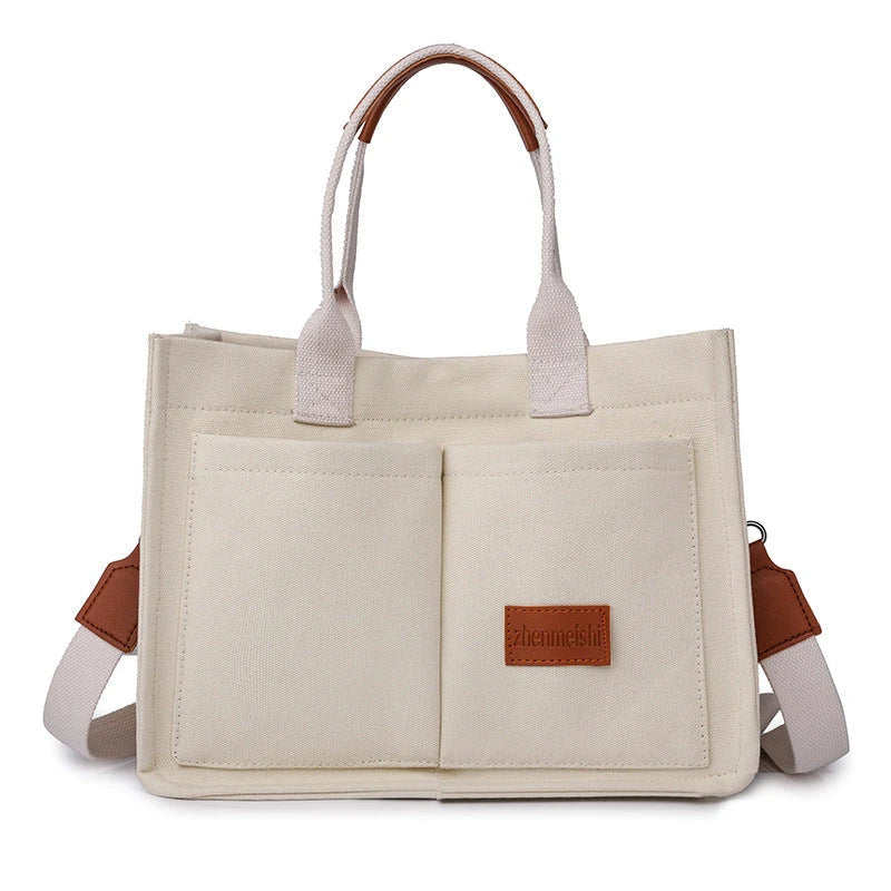 Premium canvas tote bag in multiple colors with adjustable shoulder strap and organizational pockets