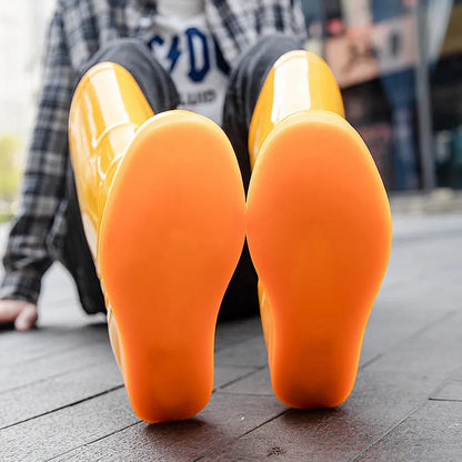 Men's white and yellow flat plastic rain boots with high tube design on a neutral background.