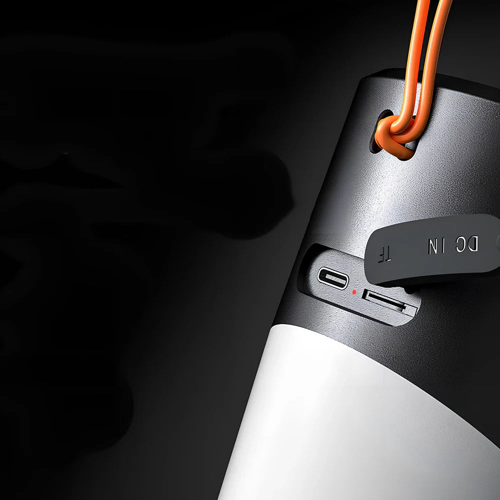 Black portable Bluetooth speaker with RGB lights, iron mesh covering, and compact circular design for outdoor audio