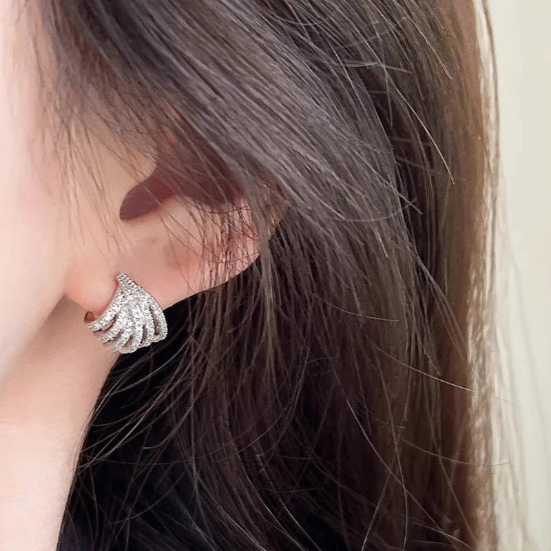 Geometric line design earrings with platinum electroplating on zircon, showing symmetrical patterns and clean architectural lines