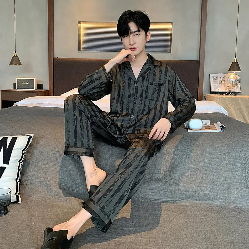 Black stripes men's ice silk pyjama set with V-neck top and long trousers on a hanger.
