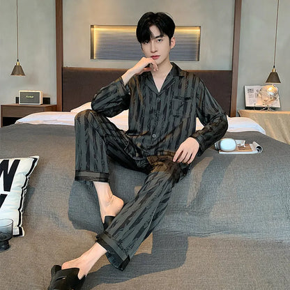 Black stripes men's ice silk pyjama set with V-neck top and long trousers on a hanger.