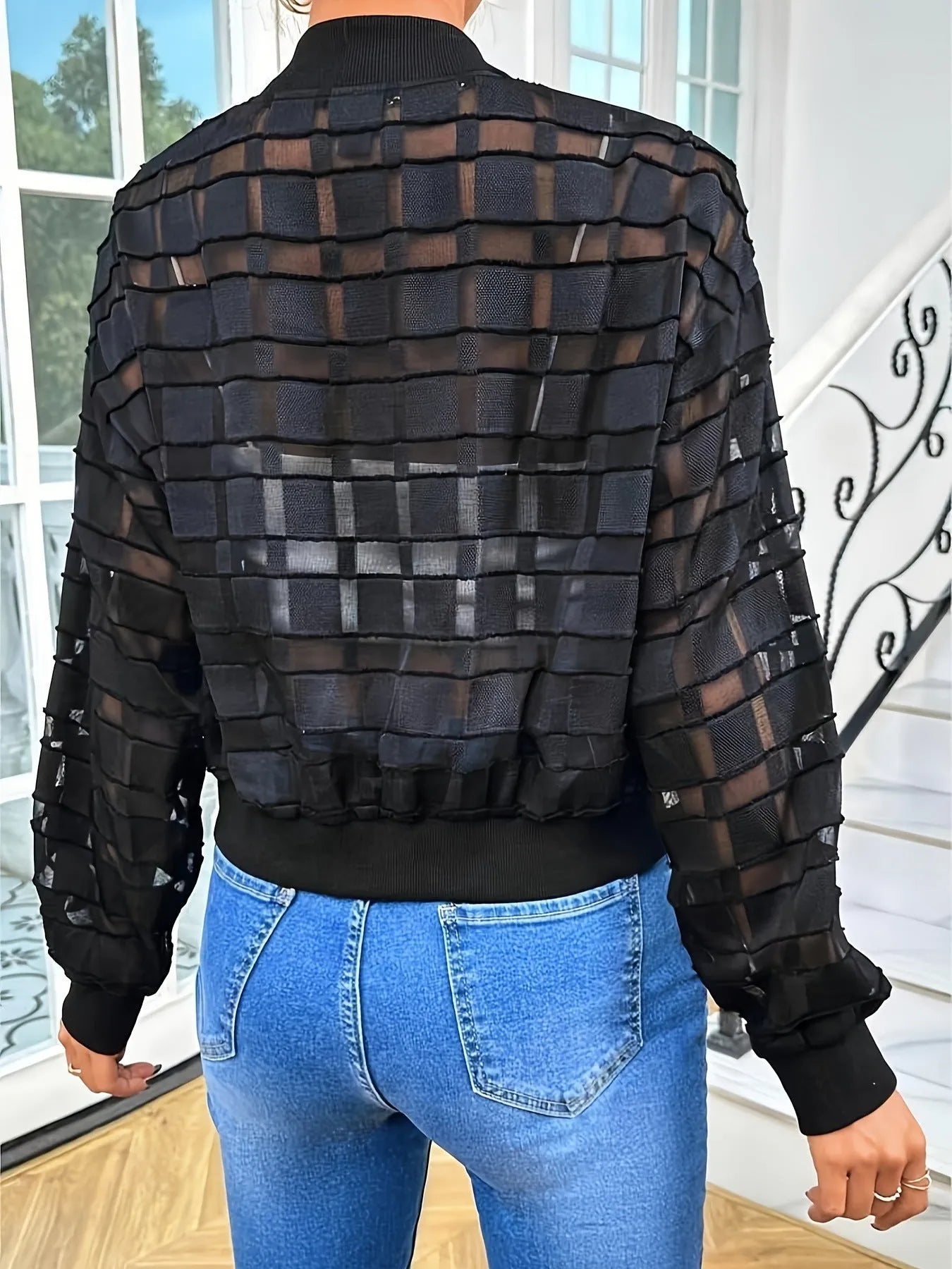 Black women's casual jacket with geometric pattern, long sleeves, and a front zipper.