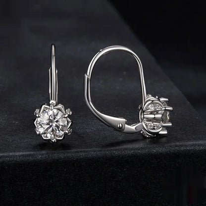 Sterling silver flower bud ear clips with white gold plating and moissanite centre stone