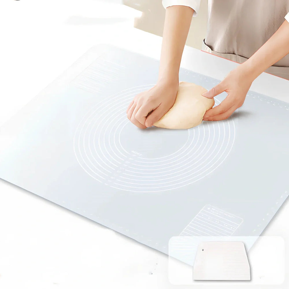 Green antibacterial silicone kneading mat with noodle cutter and rolling pin on kitchen counter