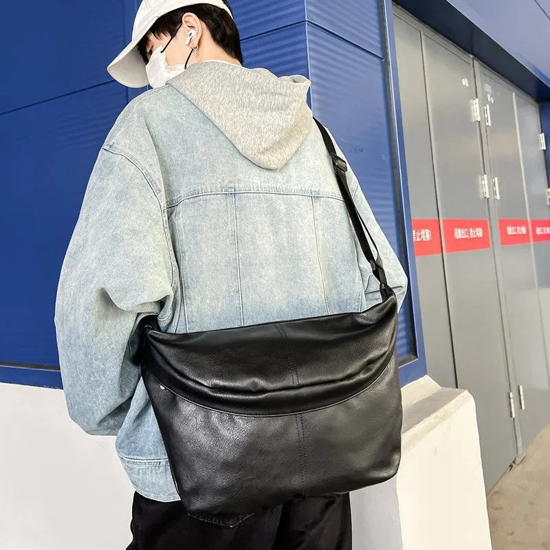 Retro style brown men's crossbody messenger bag showing storage compartments and 50cm width dimensions