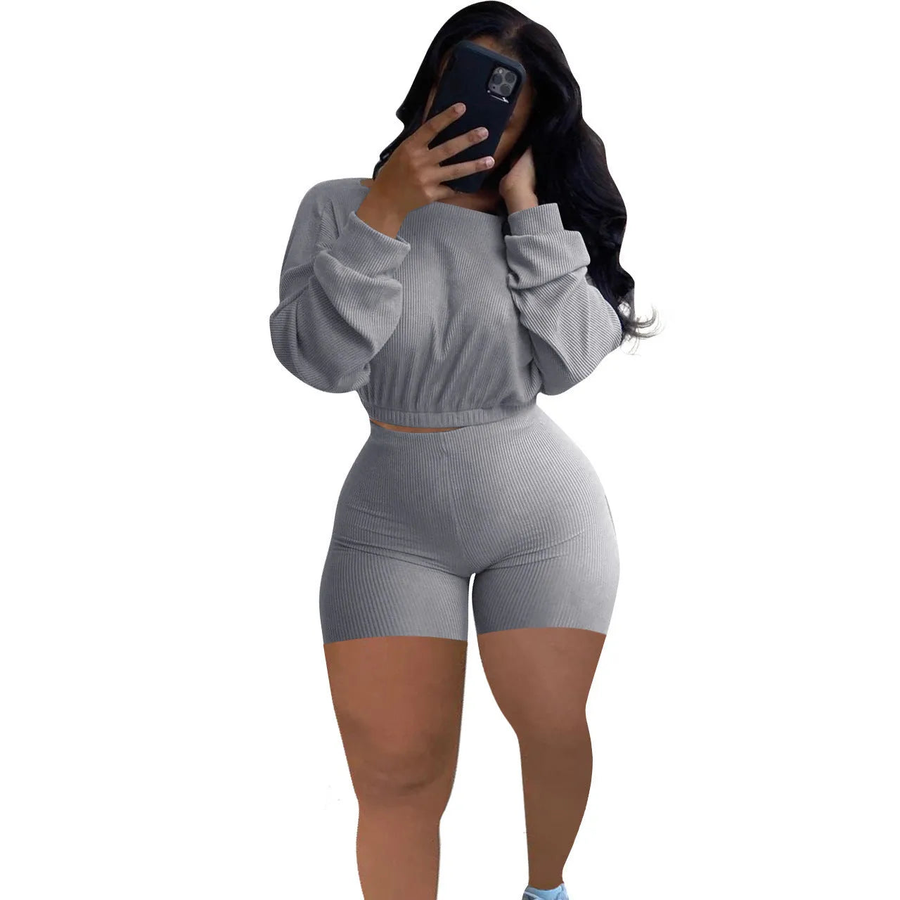 Women's long sleeve off-the-shoulder top and shorts two-piece set in a solid colour.