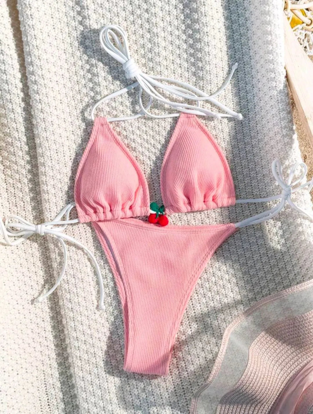 Solid colour briefs-style bikini swimsuit on a hanger, showing the top and pants.
