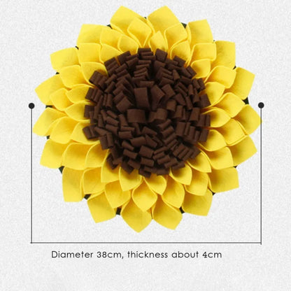 Yellow sunflower-shaped dog snuffle mat for slow feeding and nosework training on a floor.