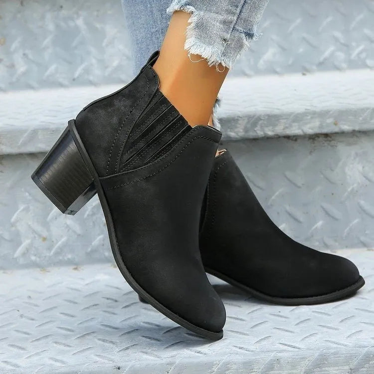 Black and brown women's ankle boots with a pointed toe and thick square low heel, slip-on design.
