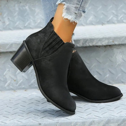 Black and brown women's ankle boots with a pointed toe and thick square low heel, slip-on design.