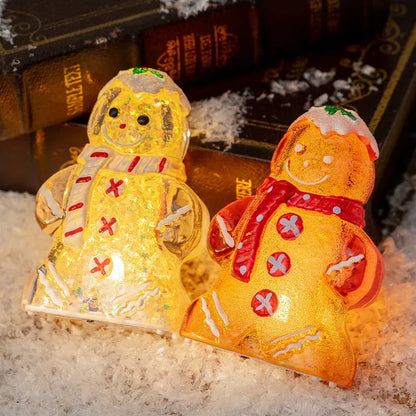Glowing gingerbread man Christmas ornament measuring 6.5cm wide with LED lights and red scarf