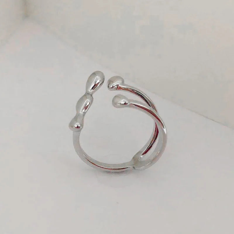 Gold and silver adjustable brass ring featuring a large spherical design on an open shank.
