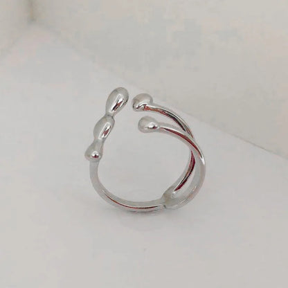 Gold and silver adjustable brass ring featuring a large spherical design on an open shank.