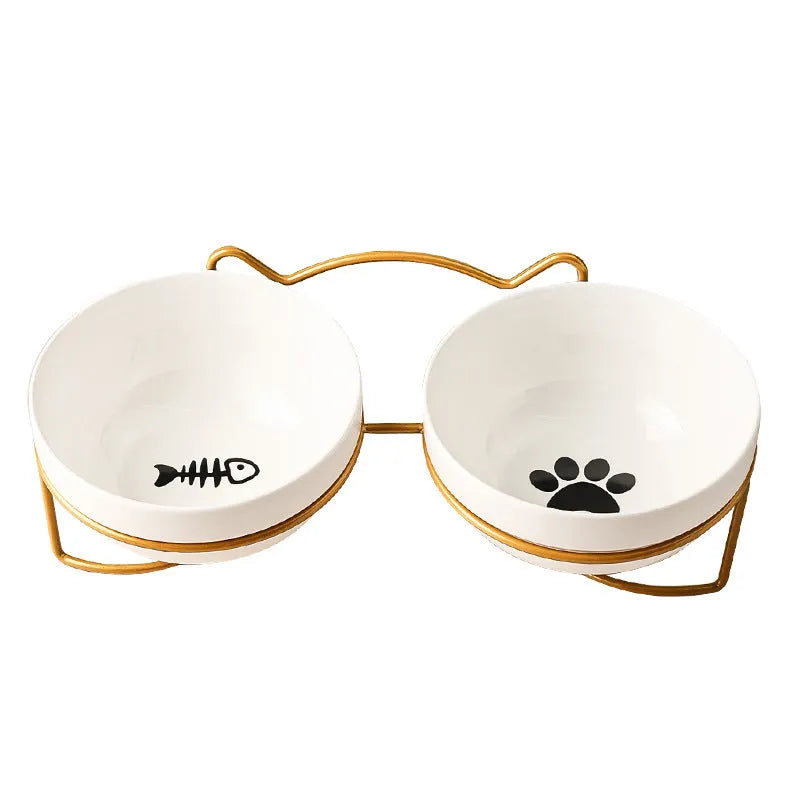 White ceramic pet bowl with cat paw design on a black iron frame raised feeder.