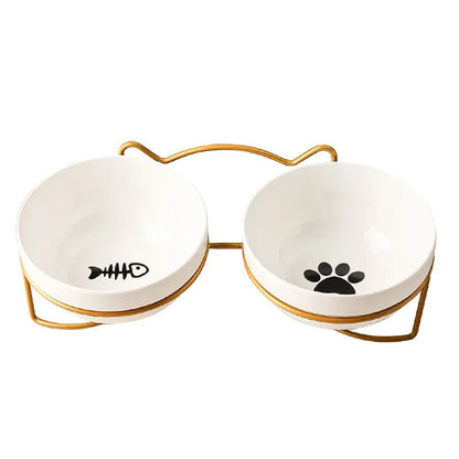 White ceramic pet bowl with cat paw design on a black iron frame raised feeder.