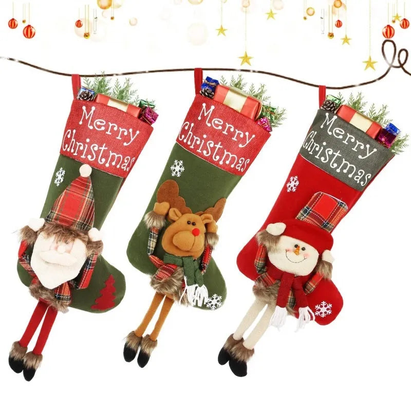 Set of three large red, white, and brown Christmas stockings with 3D Santa, Snowman, and Reindeer designs hanging on a tree.
