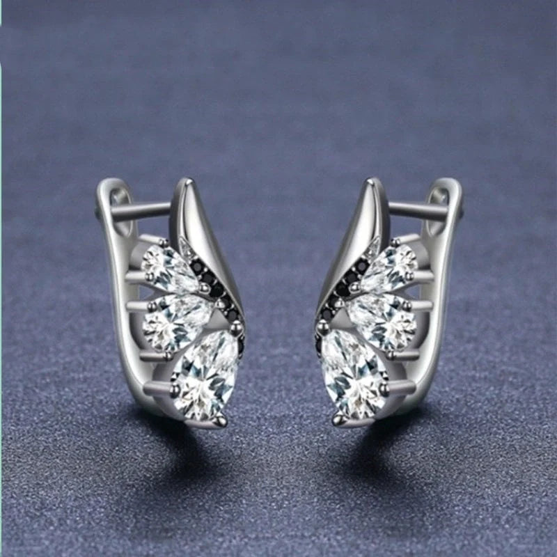 Elegant wing-shaped earrings with drop-shaped zircon stones, crafted with copper for a sophisticated and fashionable look