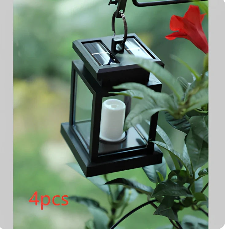 Black solar candle lamp with warm white LED illumination for outdoor gardens and patios