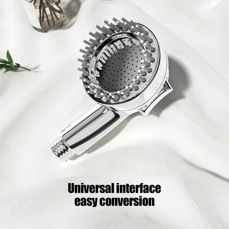 Silver dog shower attachment with silicone comb teeth and ergonomic grip for pet bathing.