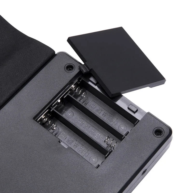 49-key folding electronic keyboard in gloss black with built-in speaker, unfolded to show silicone rubber keys and ABS plastic control panel