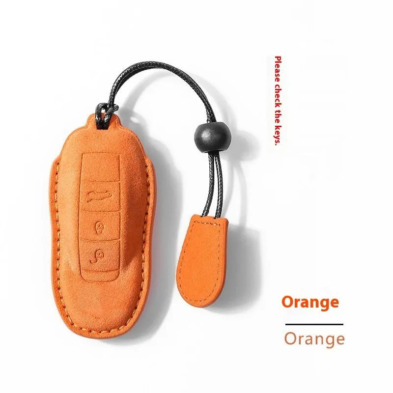 Car key cover made from suede leather in cement grey, dark green, light grey, or orange colour options with two distinct style variations, A and B, designed for protecting your vehicle key fob