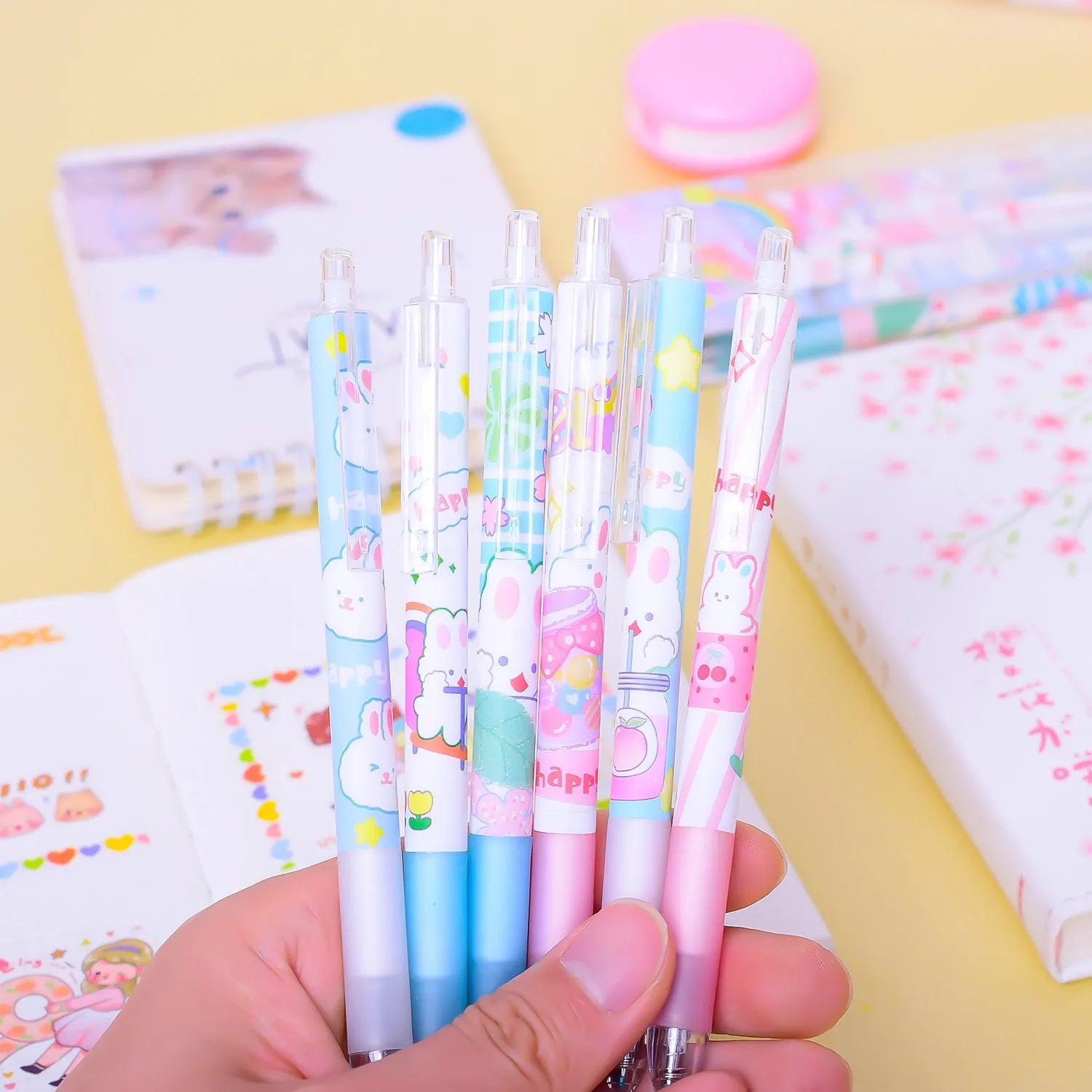 Six black ballpoint pens with cartoon bunny designs showing 0.5mm tips for writing