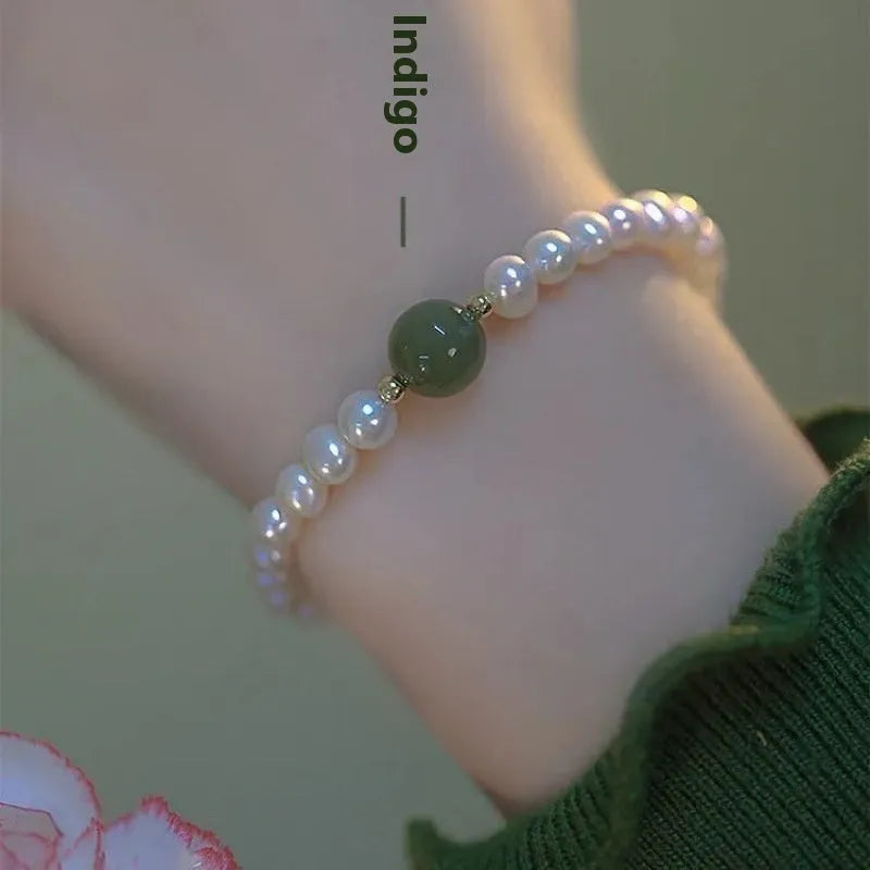 Chinese style glass bead bracelet with bamboo joint design on wrist.