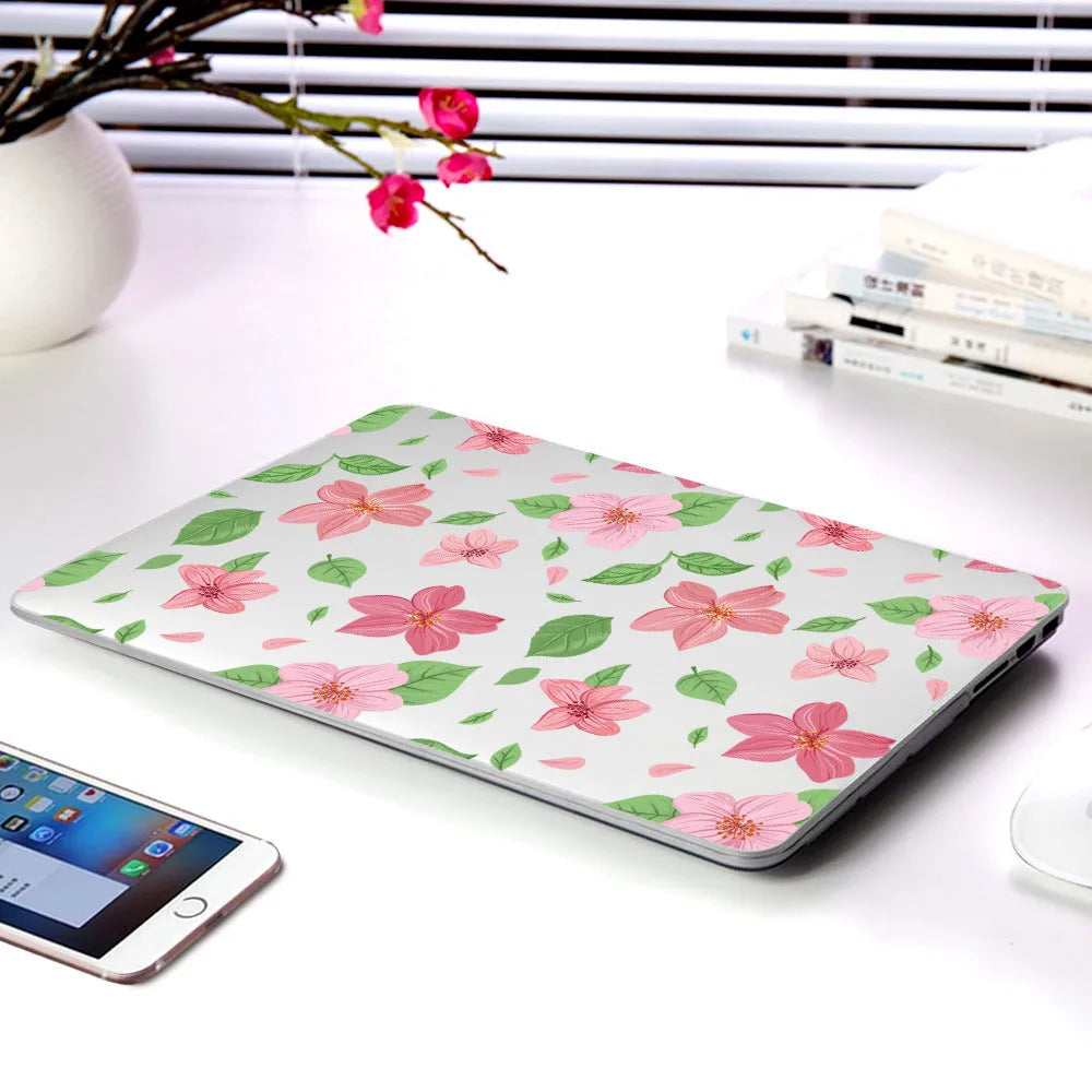Plastic protective shell with floral pattern for Apple MacBook laptop showing sampling flower design