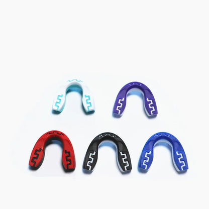 Custom mouldable boxing mouthguard with tooth socket design in black and white colour for adult combat sports.