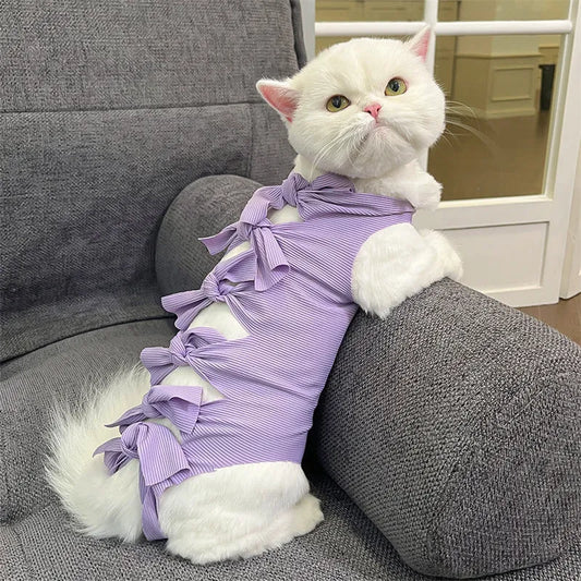 Lace-up cat sterilisation clothing in five colours including pink, purple, blue, brown, and green pineapple, showing adjustable fastening