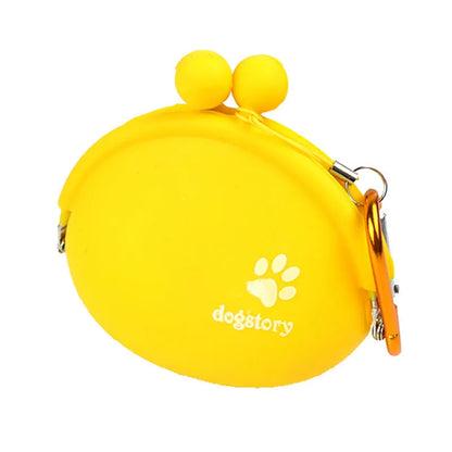Yellow silicone dog training treat pouch with a black hook and loop waist strap, shown with dog biscuits.