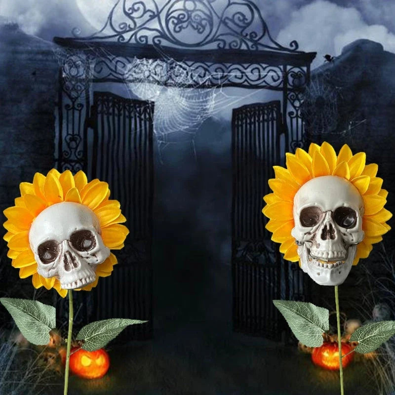A group of skull-shaped sunflower ornaments arranged in a Halloween-themed outdoor display