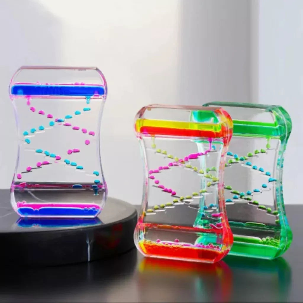 Creative Cruise Fluid Liquid Hourglass Timer with blue and pink liquid on desk