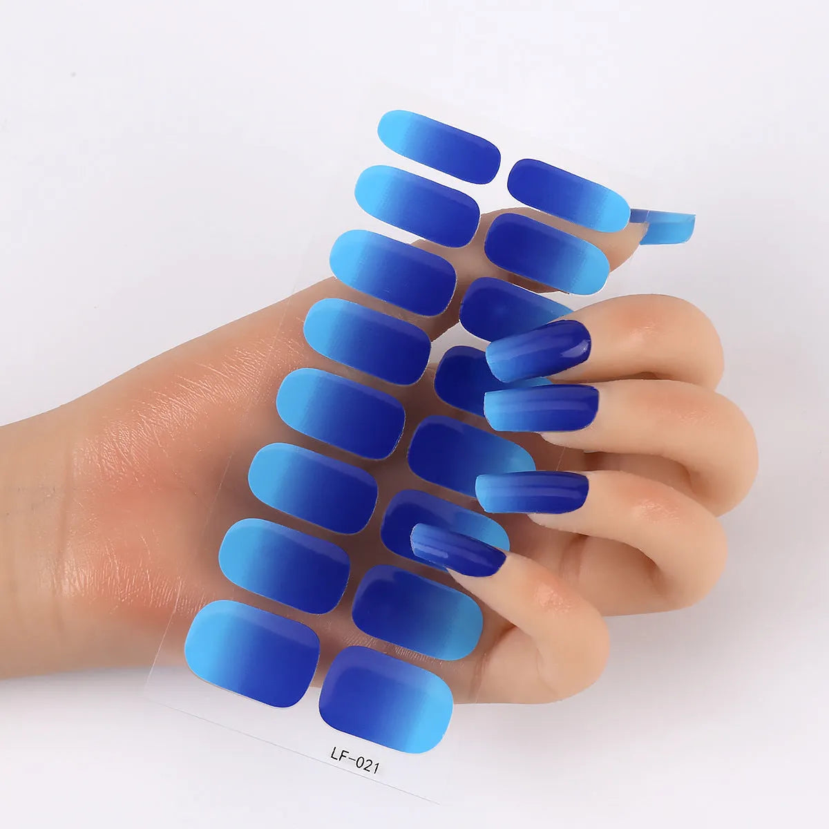 Sheet of 16 small design nail art stickers including cross, rose, tulip and marble patterns.