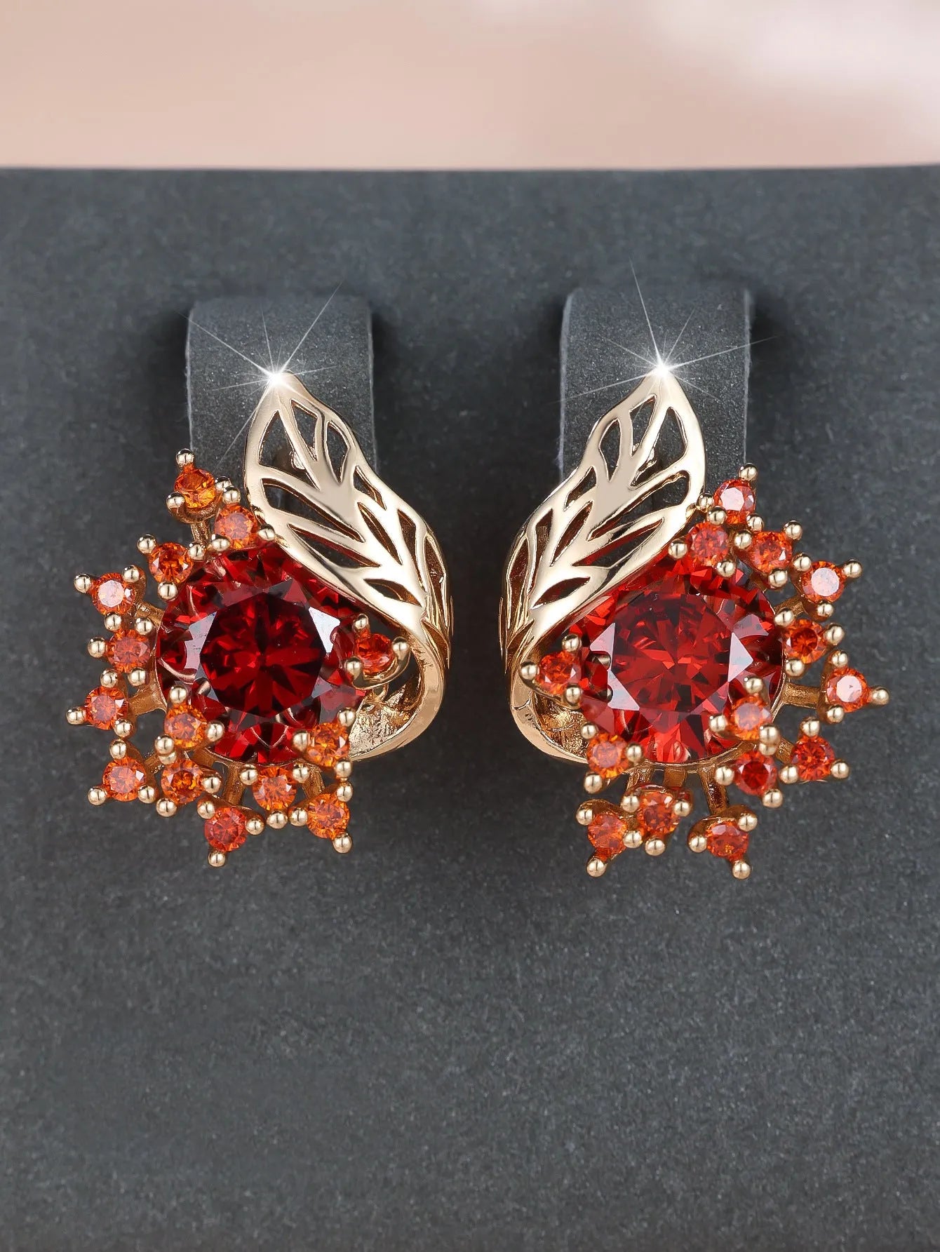 Round flower and feather design earrings in champagne gold with a choice of coloured zircon stones.