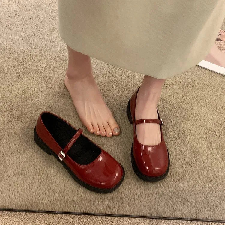 Women's solid colour French vintage leather shoes with round toe and flat heel design in red, black, and grey options
