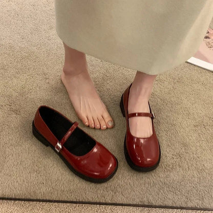 Women's solid colour French vintage leather shoes with round toe and flat heel design in red, black, and grey options