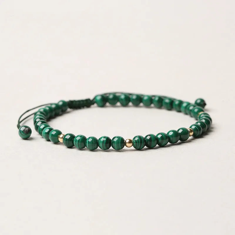 Women's malachite crystal bracelet with golden balls and handwoven design