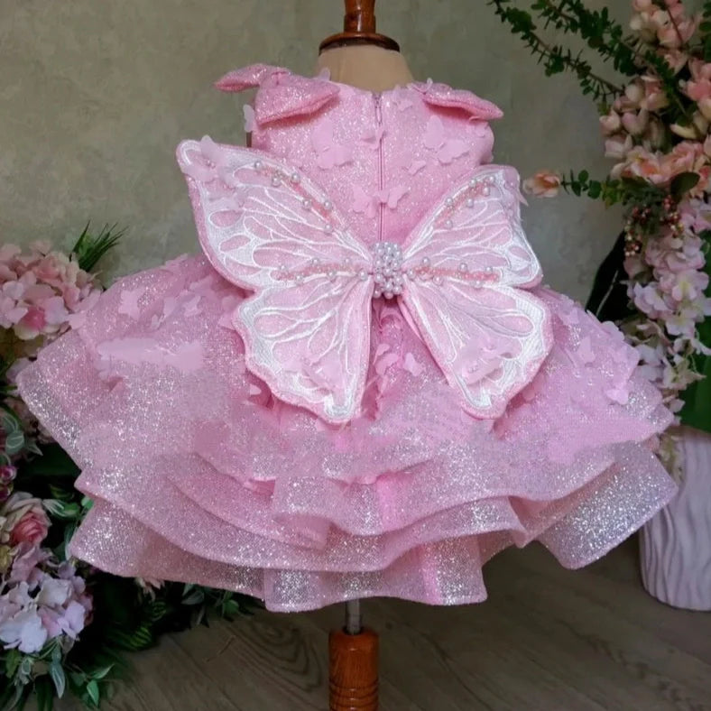 Pink sleeveless girls' dress with three-dimensional butterfly decoration on front