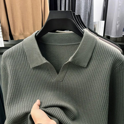 Man wearing a loose fit camel coloured pullover sweater, a casual autumn layer with a simple design.